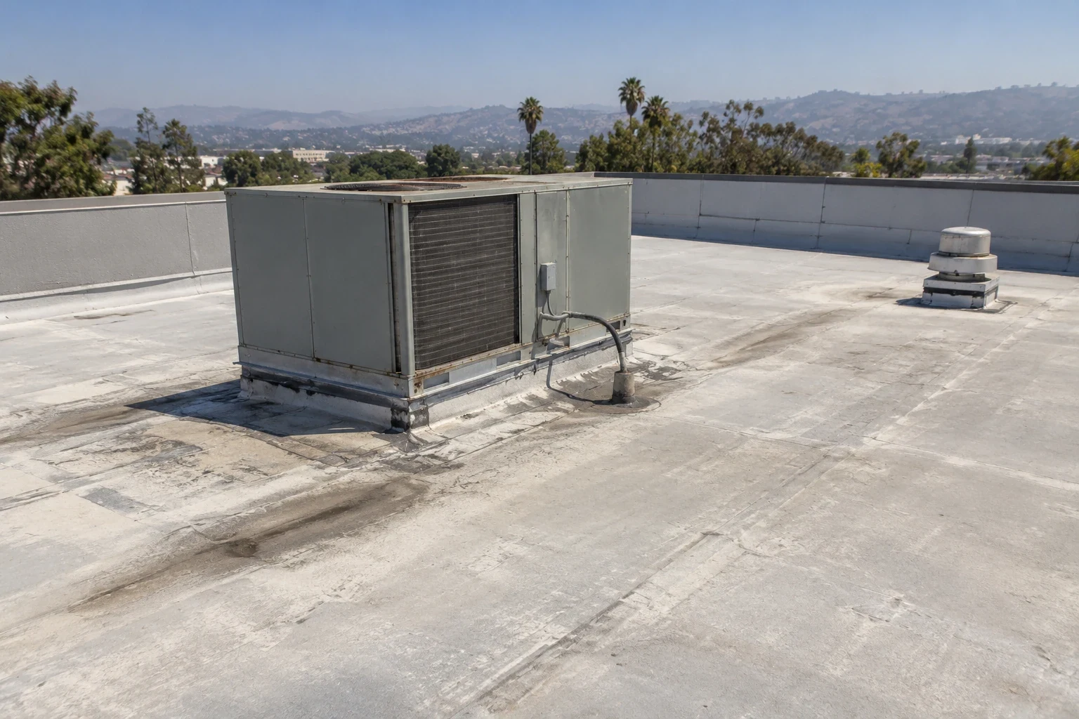 Roof technician inspecting a commercial roof